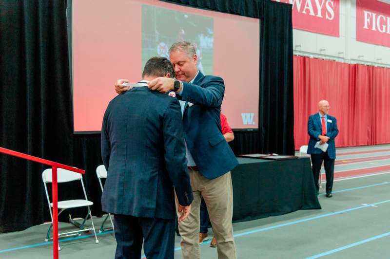 a man hugging another man