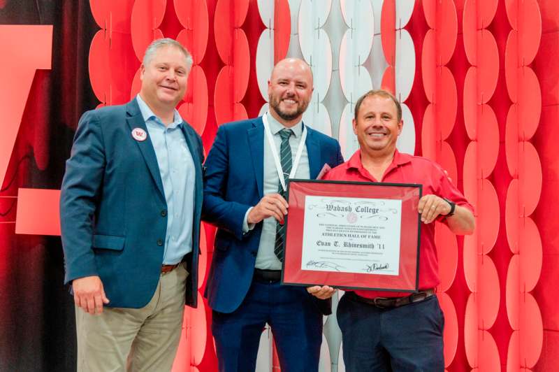 a group of men holding a certificate