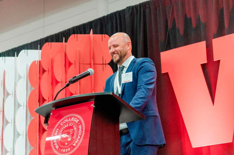 a man standing at a podium with a microphone