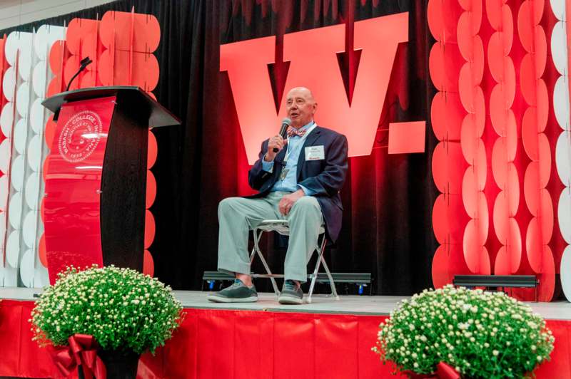 a man sitting on a stage