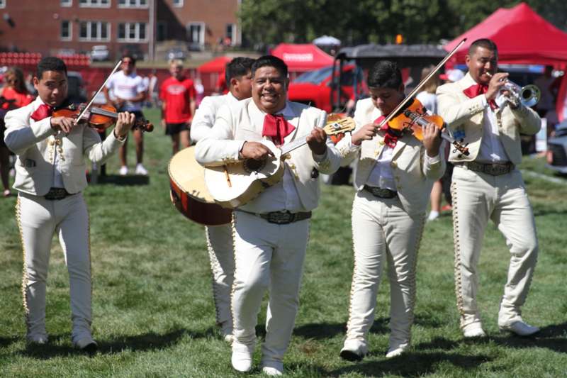 a group of men in white suits playing instruments