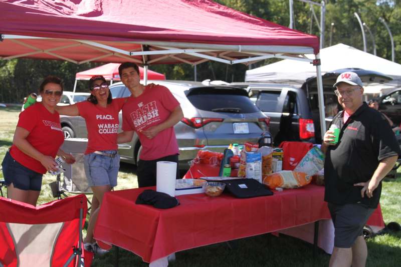 a group of people standing under a tent