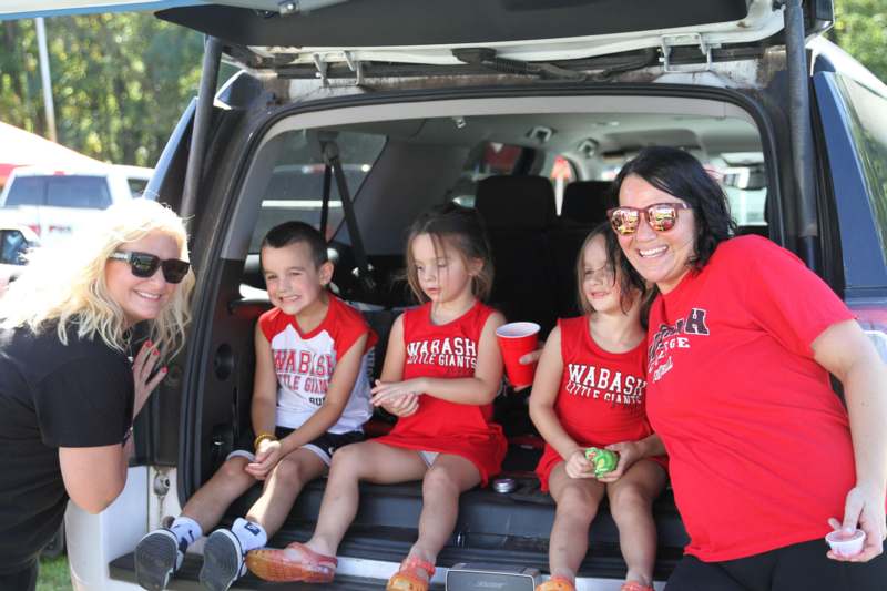 a group of people sitting in the back of a car