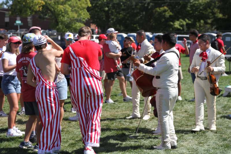 a group of people in striped pants playing instruments