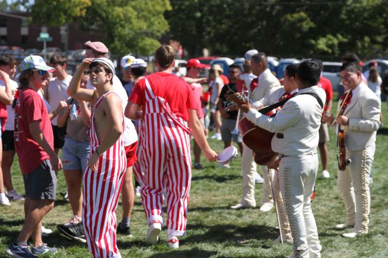 a group of people in striped overalls