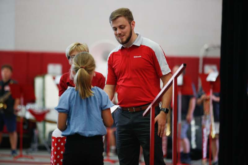 a man standing next to a girl