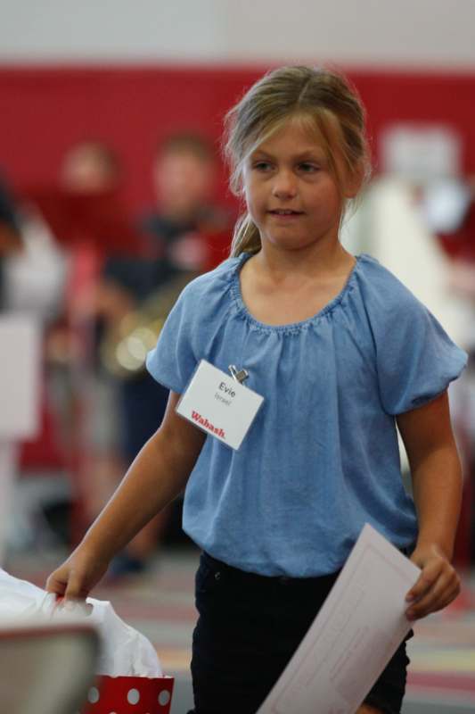 a girl holding a piece of paper