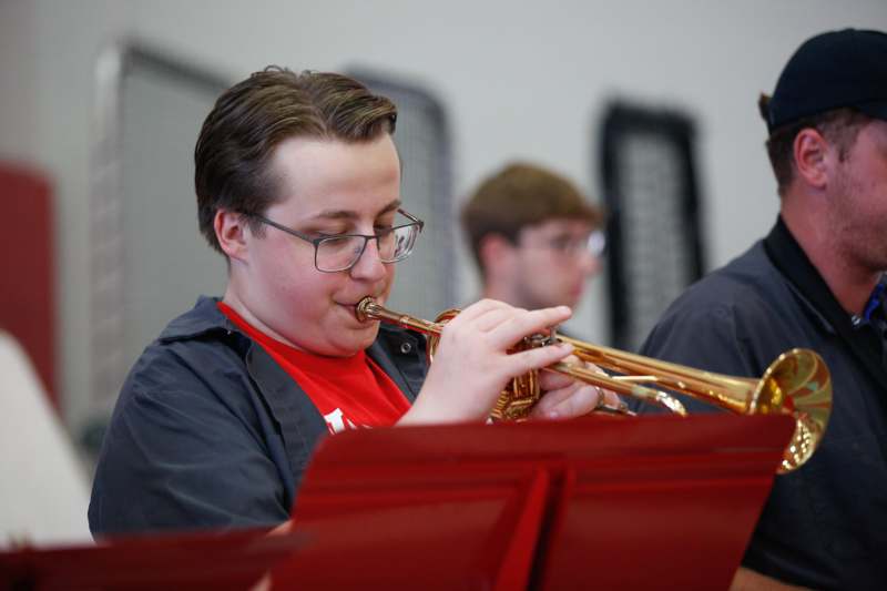 a boy playing a trumpet