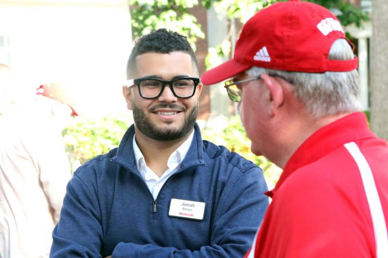 a man wearing glasses and a badge with a name tag