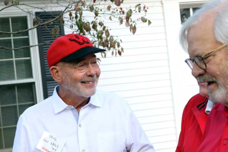 a man in a red hat talking to a woman