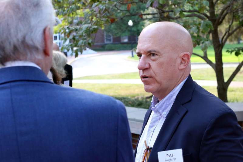 a man in a suit talking to another man