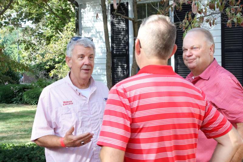 a group of men talking outside