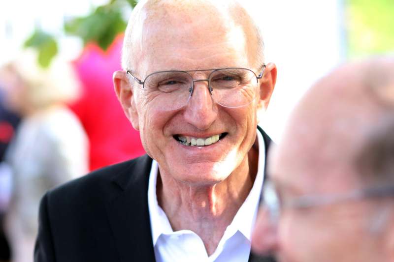 a man wearing glasses and smiling