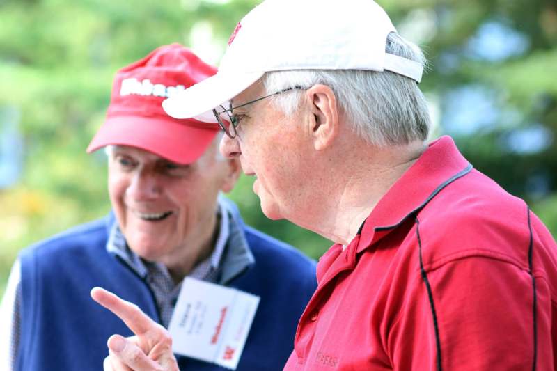 a group of men wearing red shirts and hats