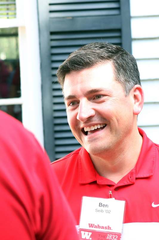 a man in red shirt smiling