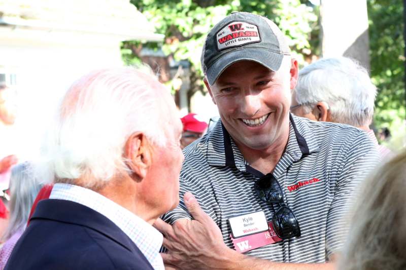 a man in a hat talking to a man