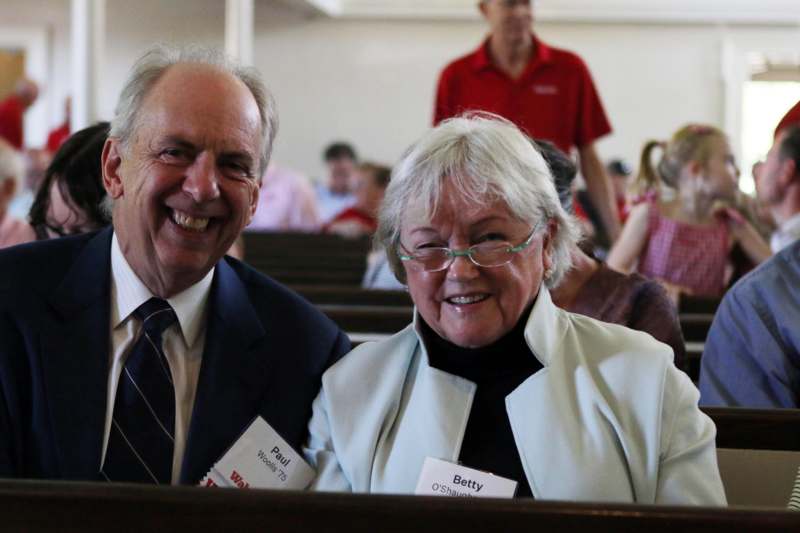 a man and woman smiling at the camera