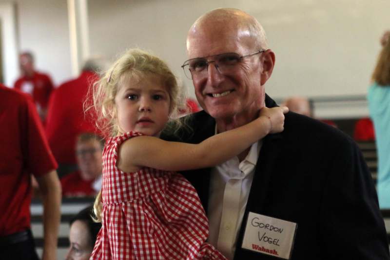 a man holding a little girl