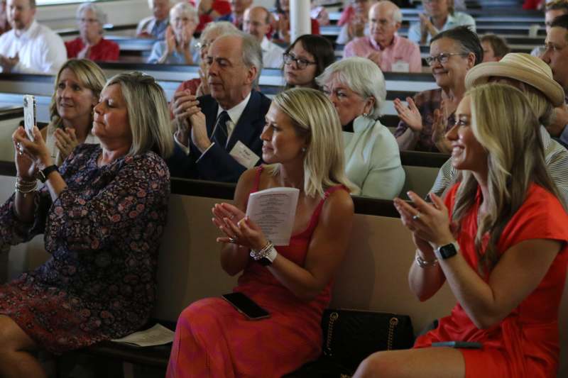 a group of people clapping in a church