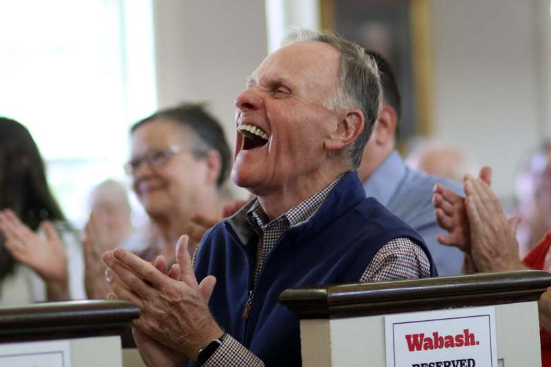 a man laughing with his hands together