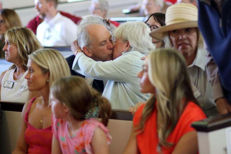 a man and woman kissing in a church