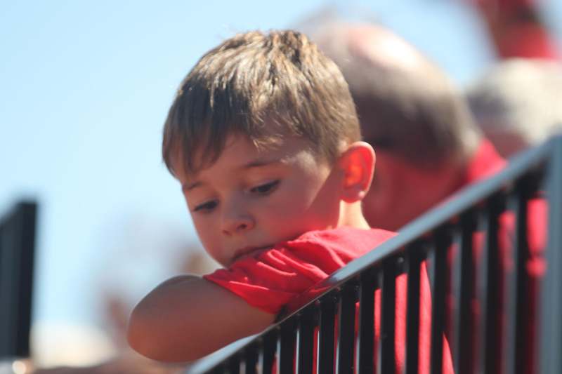 a boy leaning on a railing