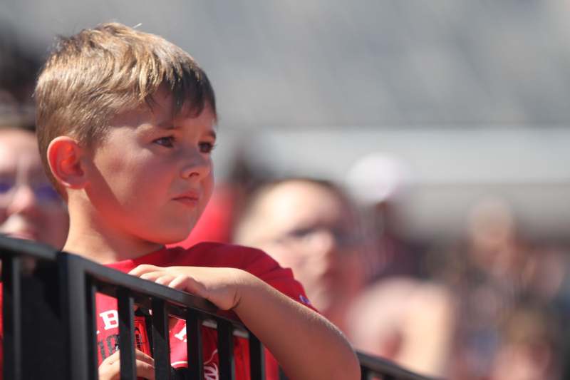 a boy leaning on a railing