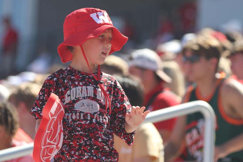 a child wearing a red hat and a red shirt