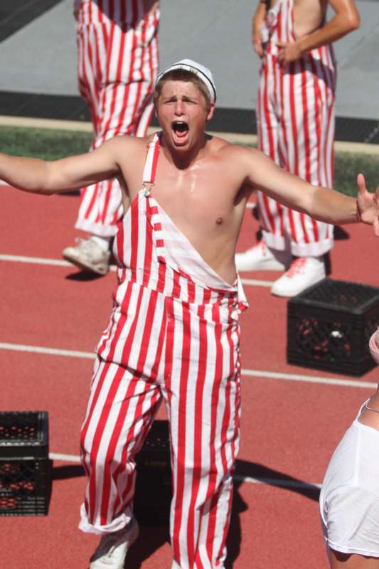 a man in red and white striped overalls