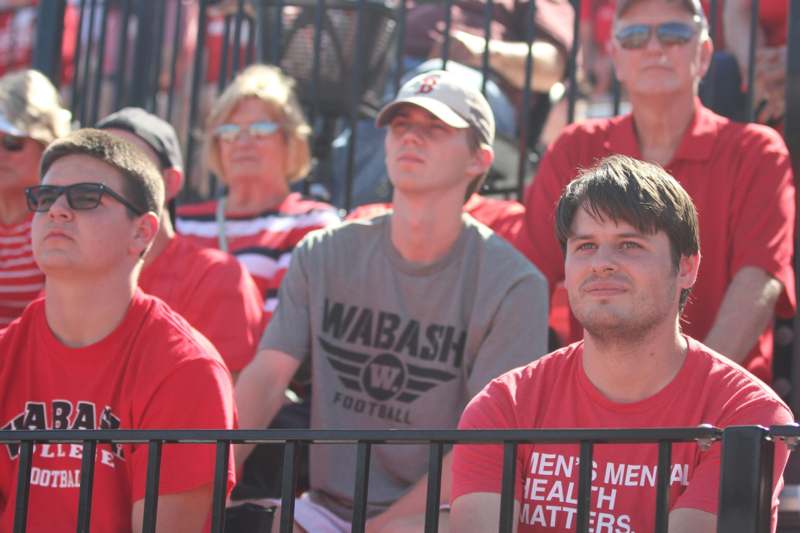 a group of people sitting in a stadium