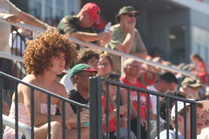 a group of people sitting in bleachers