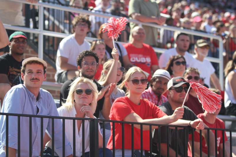 a group of people sitting in bleachers