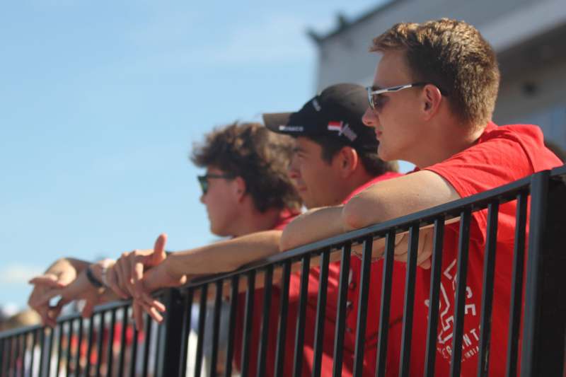 a group of men leaning on a railing