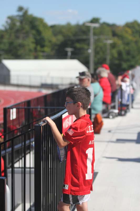 a boy leaning on a railing