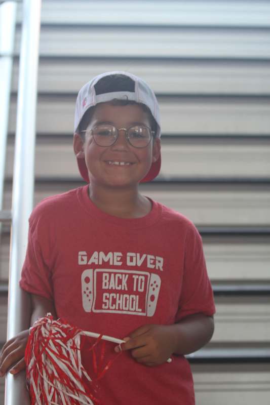 a boy wearing a red shirt and glasses