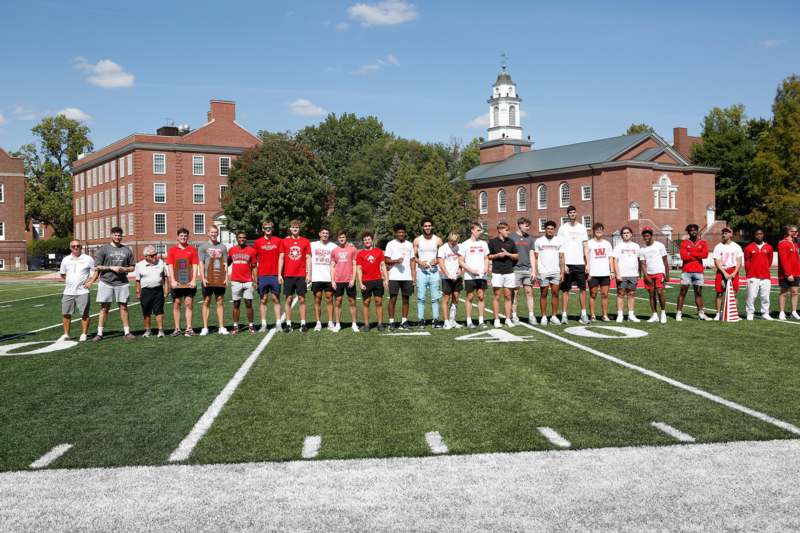 a group of people standing on a football field