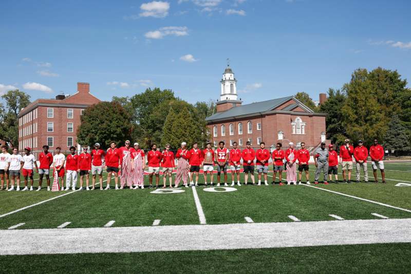 a group of people standing on a football field