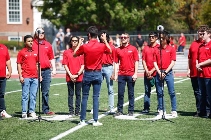 a group of people standing on a football field