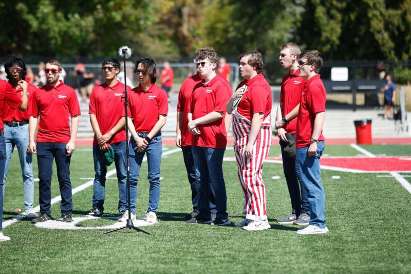 a group of people standing on a field