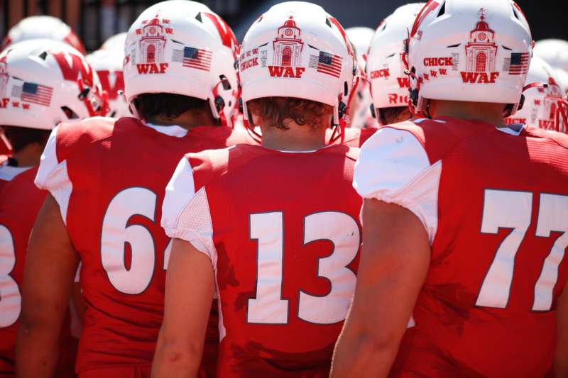 a group of football players in red uniforms