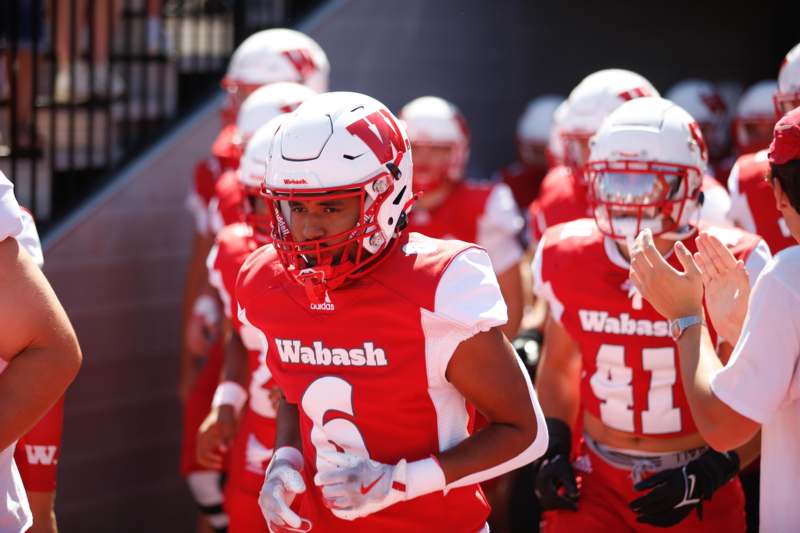 a group of football players in red and white uniforms