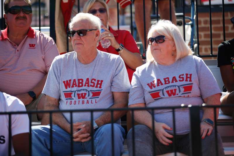 a group of people sitting on bleachers