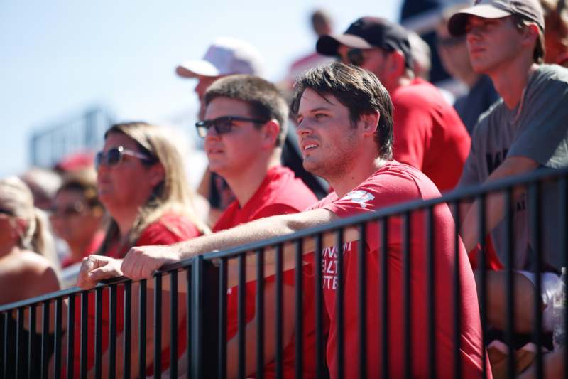 a group of people in red shirts