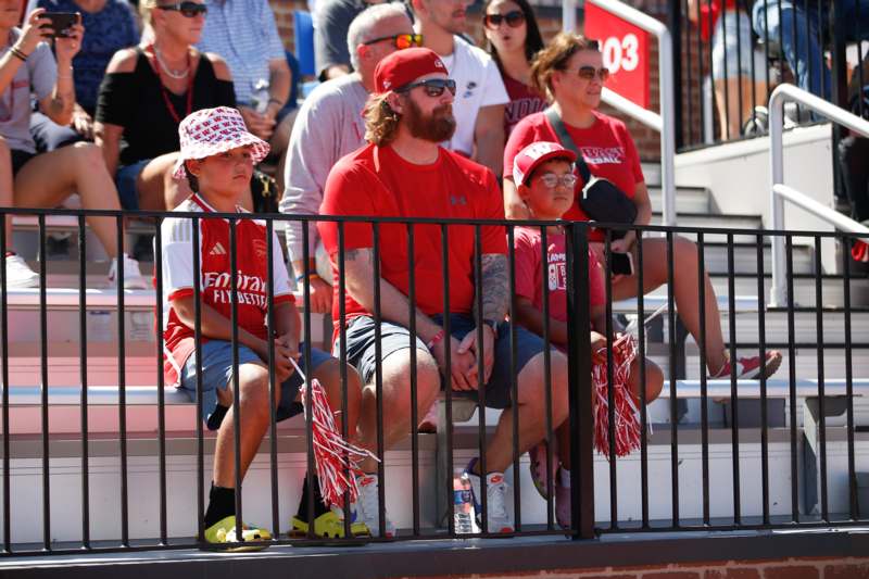 a group of people sitting on bleachers