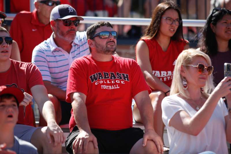 a group of people sitting on bleachers