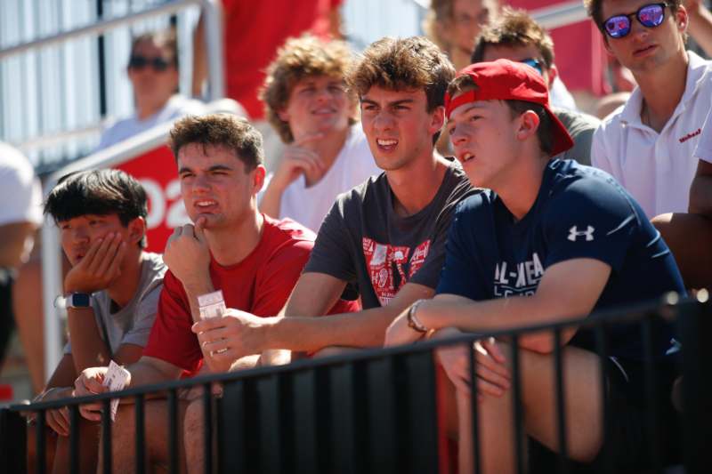 a group of people sitting in bleachers