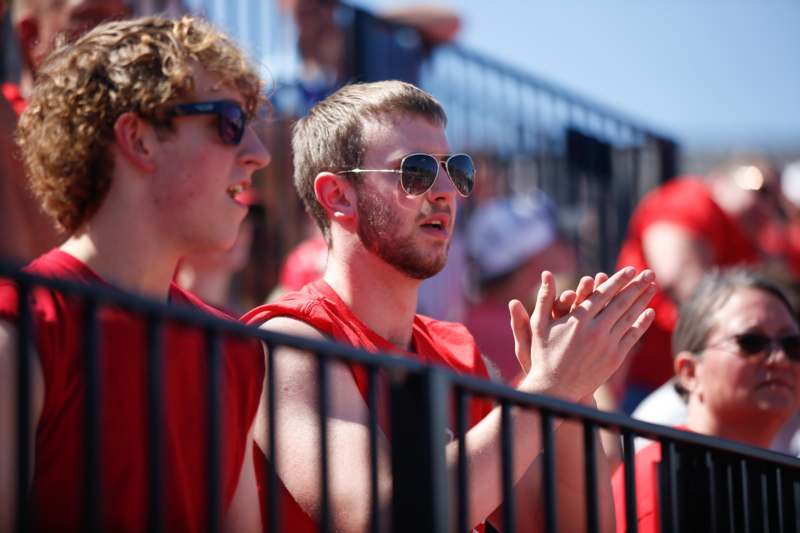 a group of men in red shirts