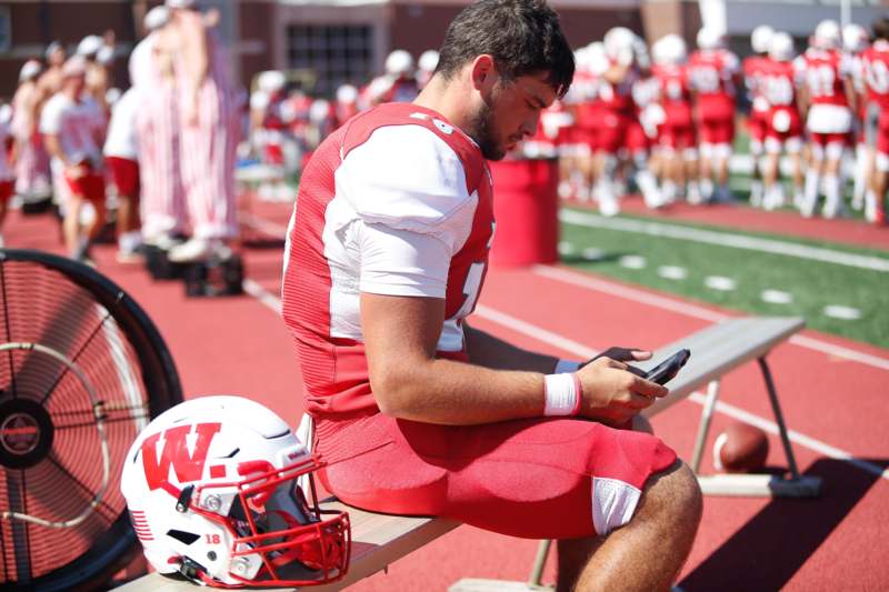 a football player sitting on a bench