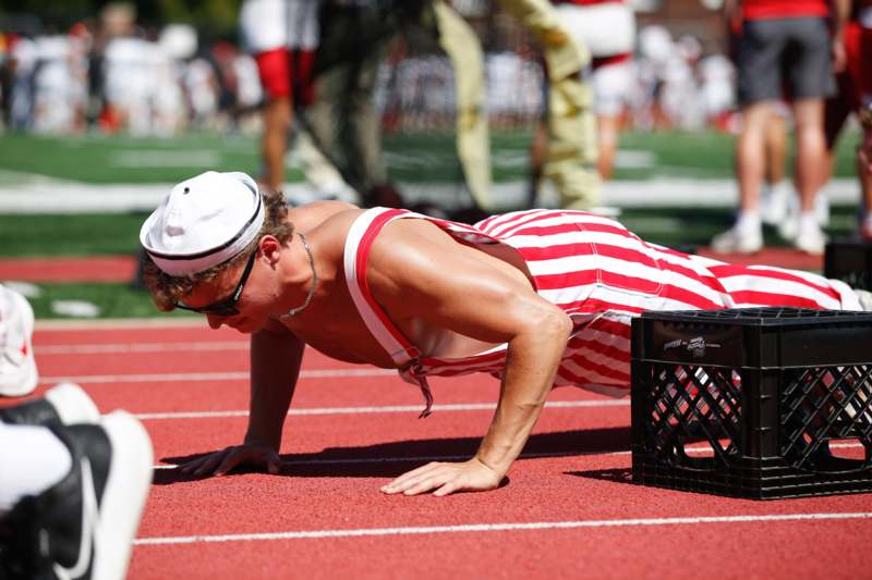 a man doing push ups on a track