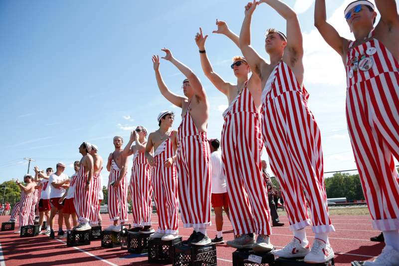 a group of men wearing striped overalls